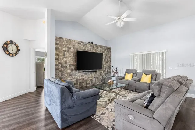 a living room with furniture and a flat screen tv