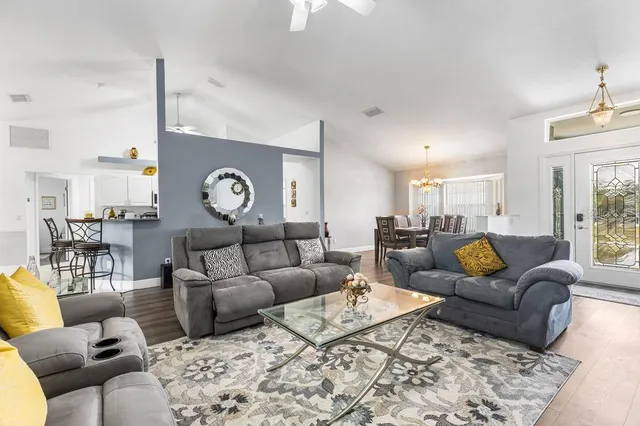 a living room with furniture a rug and a chandelier