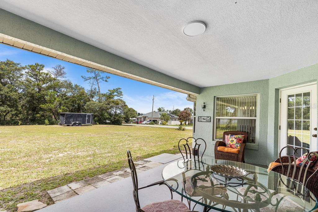 10360 Southwest 48th Avenue Ocala, FL 34476 - Photo 5 of 25 a living room with furniture and a large window with garden view