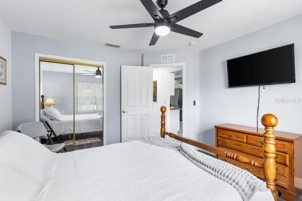 a bedroom with a bed and flat screen tv