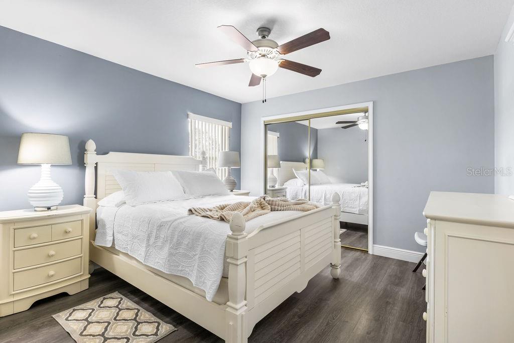 10360 Southwest 48th Avenue Ocala, FL 34476 - Photo 9 of 25 a bedroom with a bed and a chandelier