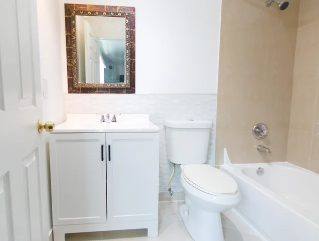 a white toilet sitting next to a bathroom sink