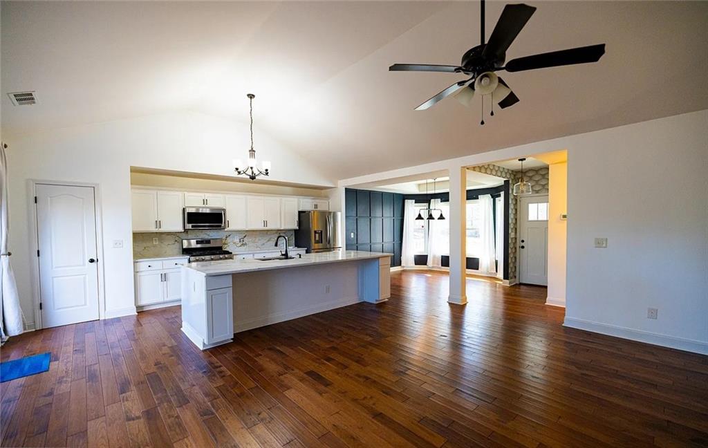 4110 Doubletree Court Cumming, GA 30040 - Photo 13 of 37 a large kitchen with cabinets wooden floor and stainless steel appliances