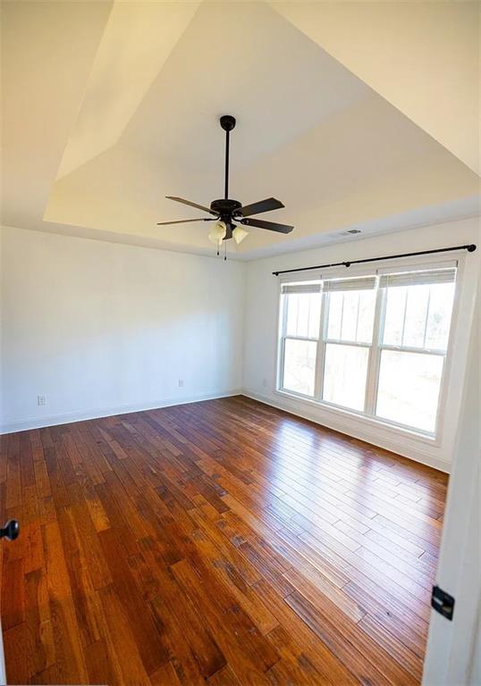 4110 Doubletree Court Cumming, GA 30040 - Photo 15 of 37 an empty room with wooden floor fan and windows