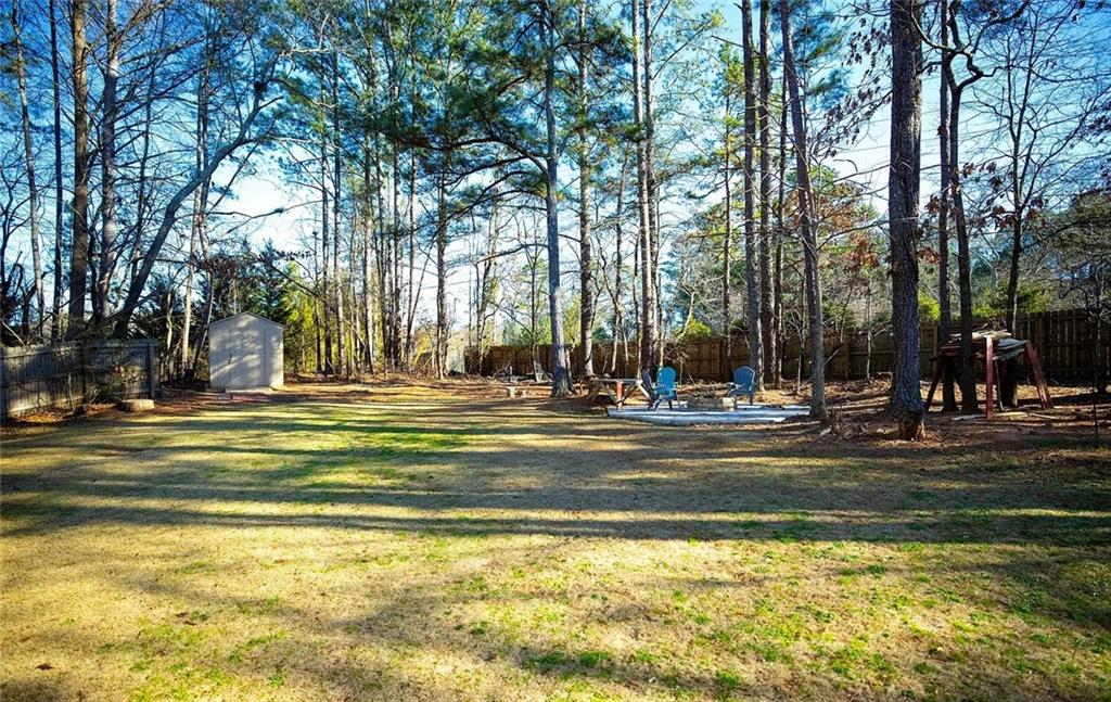 4110 Doubletree Court Cumming, GA 30040 - Photo 21 of 37 a view of a swimming pool with trees in the background