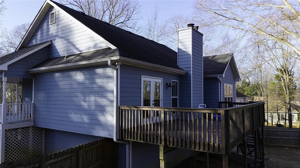 4110 Doubletree Court Cumming, GA 30040 - Photo 23 of 37 a view of a brick house with wooden fence