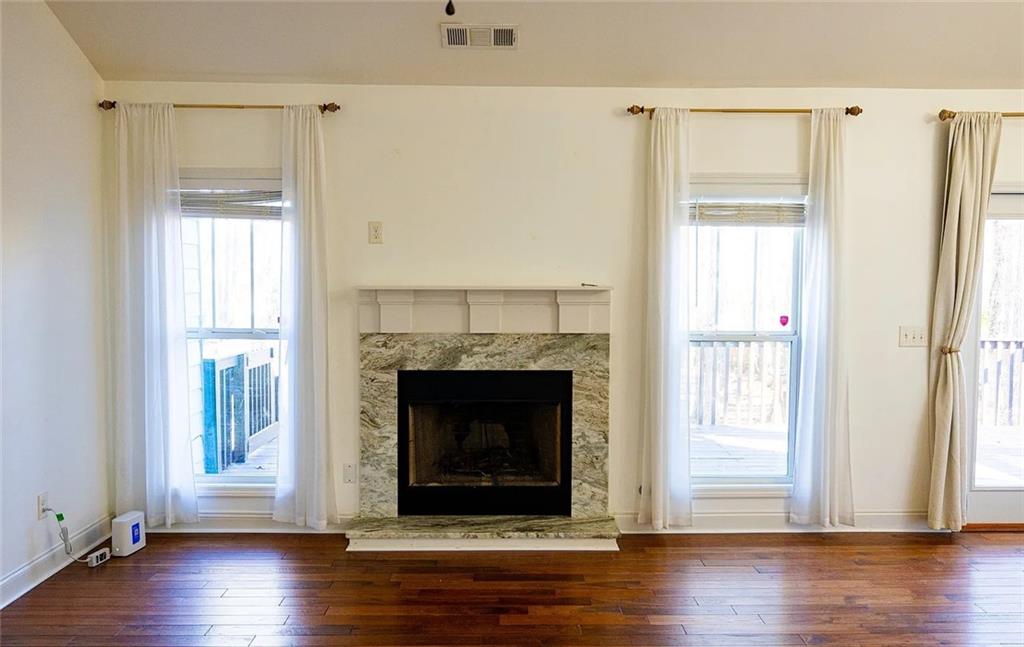 4110 Doubletree Court Cumming, GA 30040 - Photo 4 of 37 a view of an empty room with wooden floor and a window