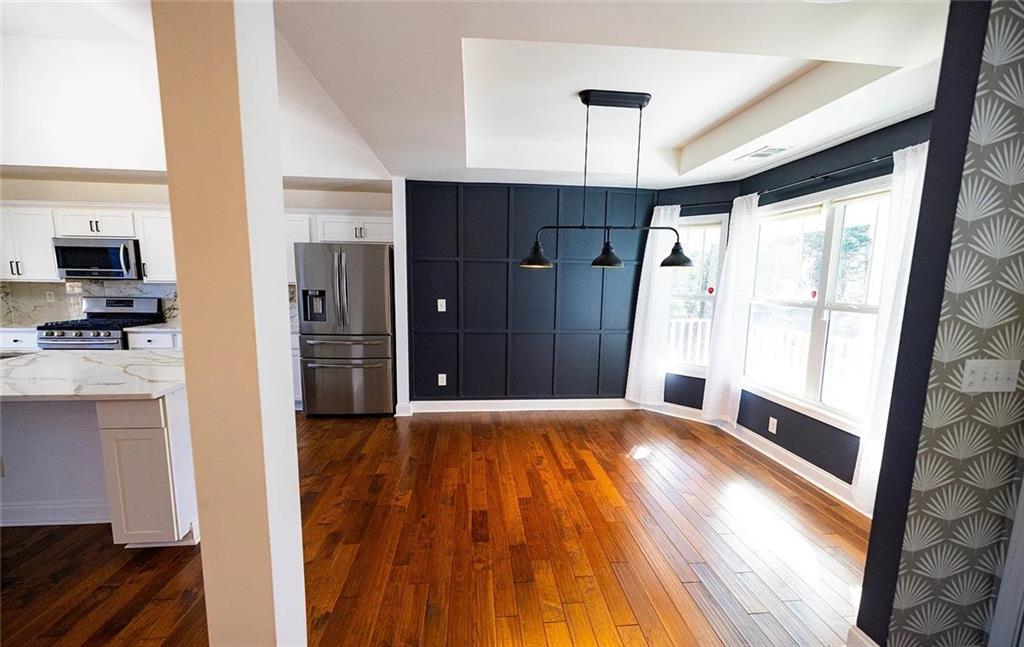 4110 Doubletree Court Cumming, GA 30040 - Photo 5 of 37 a view of a kitchen with a sink and a refrigerator
