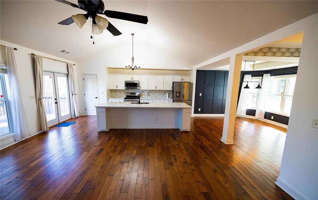 4110 Doubletree Court Cumming, GA 30040 - Photo 6 of 37 a large kitchen with stainless steel appliances granite countertop a wooden floors