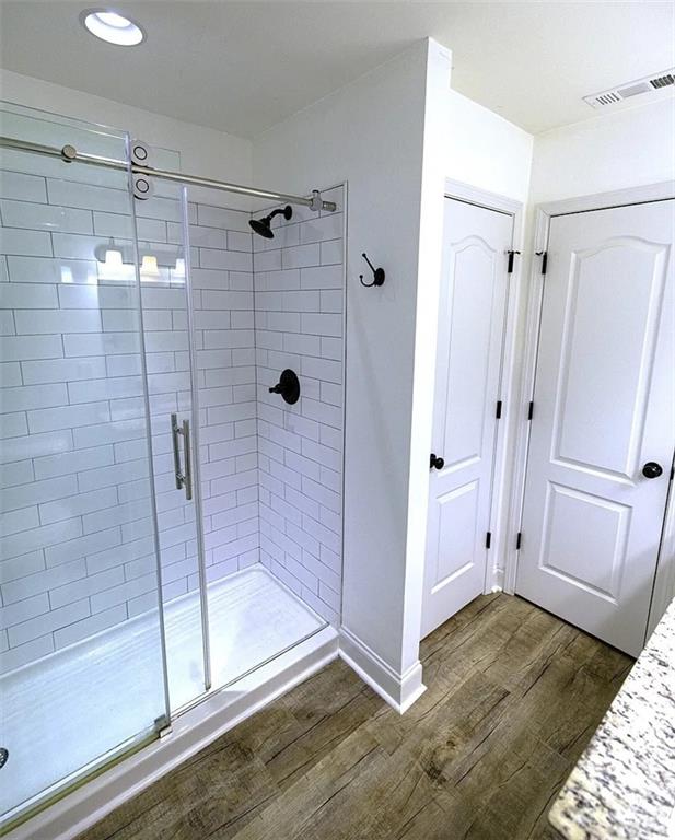 4110 Doubletree Court Cumming, GA 30040 - Photo 10 of 37 a bathroom with a glass shower door