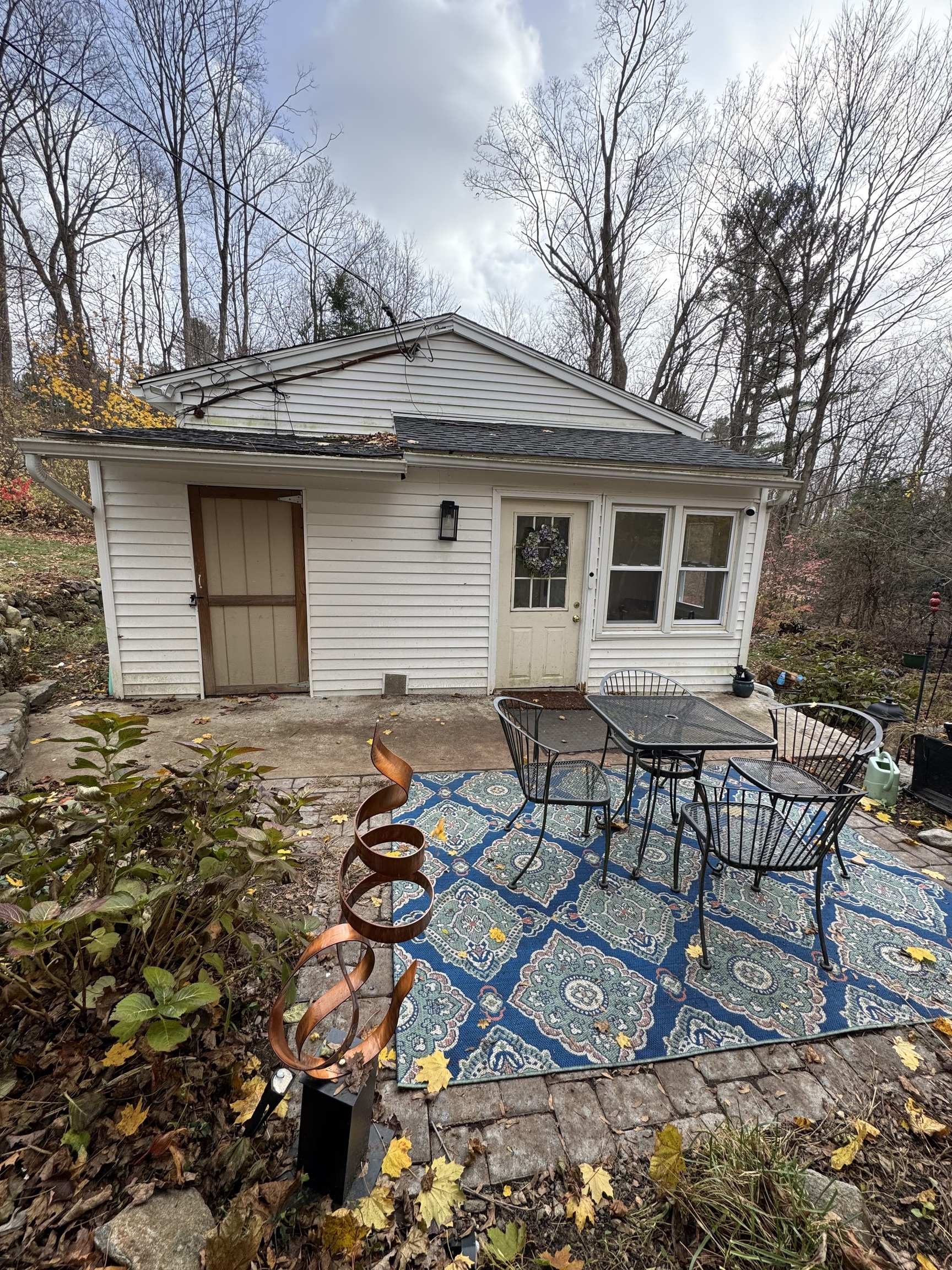 a backyard of a house with table and chairs
