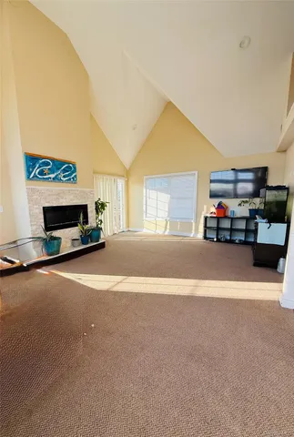 a view of staircase with lots of frames on wall and a chandelier