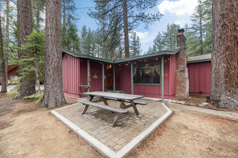 a view of a house with backyard sitting area and porch