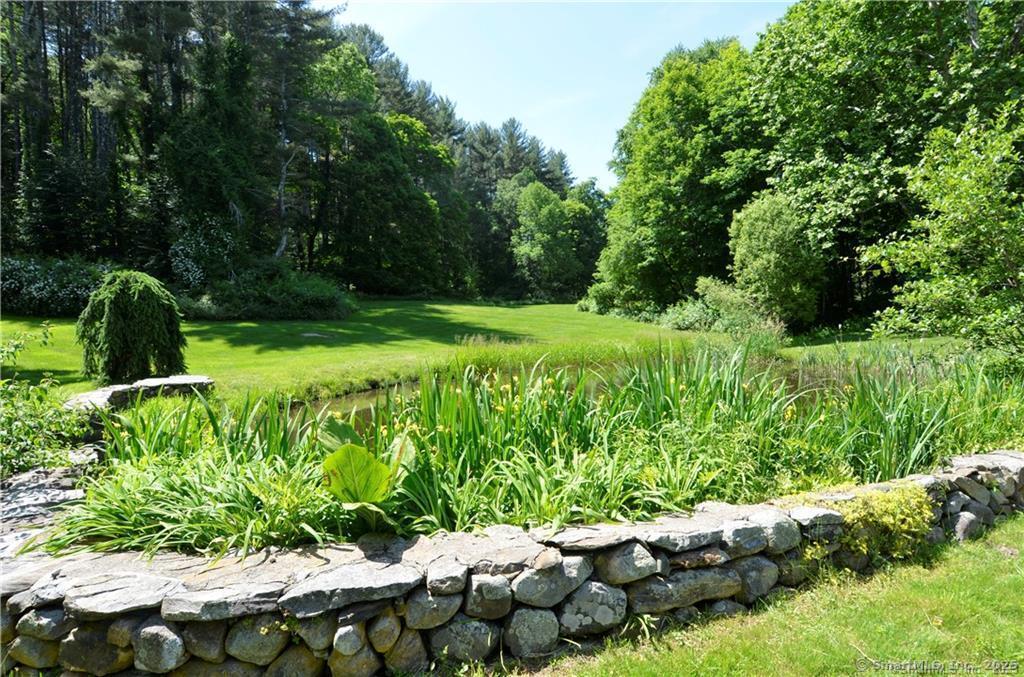 115 River Road Washington, CT 06794 - Photo 37 of 39 a view of a garden with a bench
