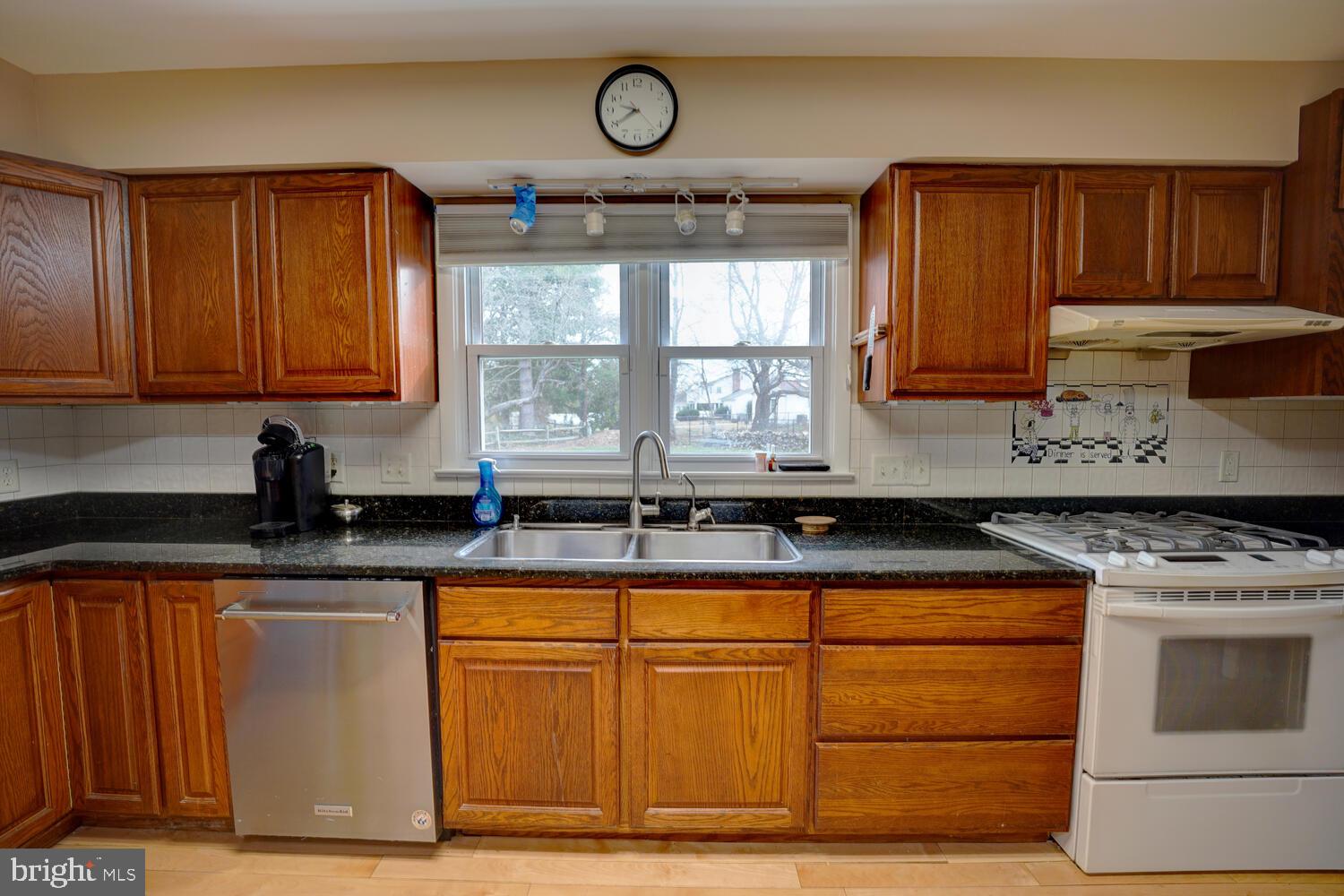 55 Beloit Avenue Dover, DE 19901 - Photo 22 of 54 a kitchen with granite countertop a stove a cabinets and a refrigerator