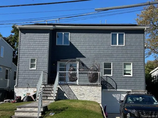 a view of backyard with a car parked in front of it
