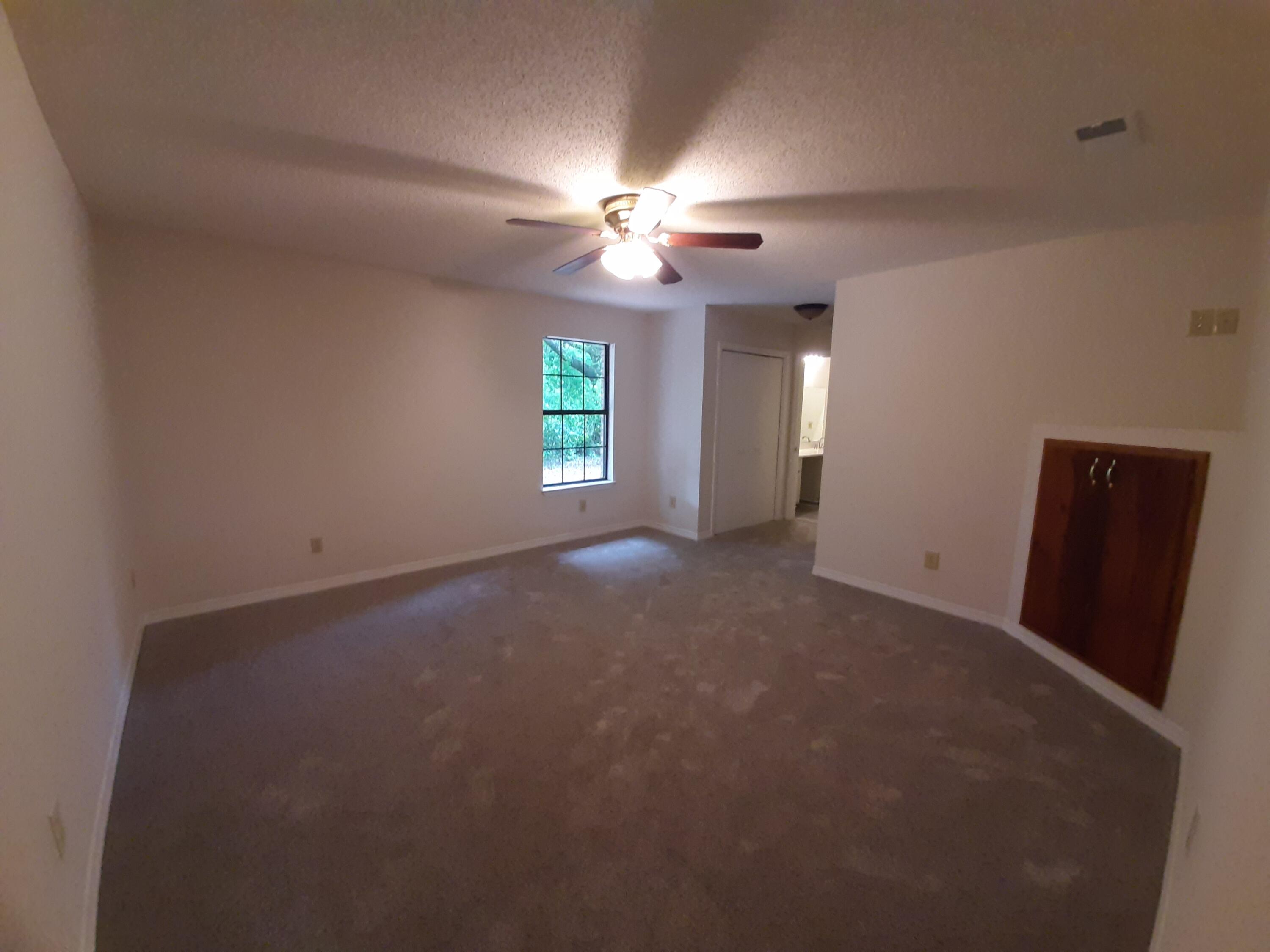 6197 Barnes Road Crestview, FL 32536 - Photo 20 of 35 an empty room with windows and fan