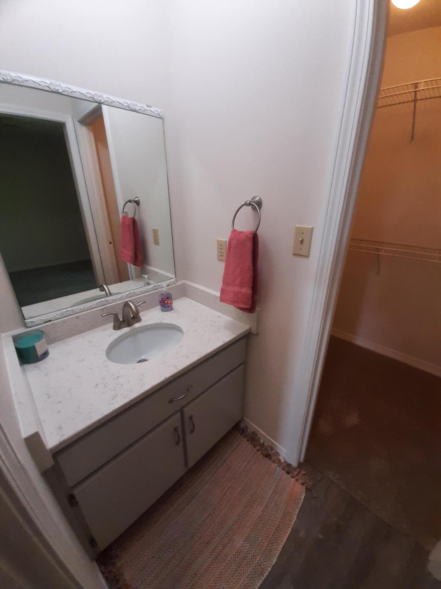6197 Barnes Road Crestview, FL 32536 - Photo 31 of 35 a bathroom with a sink and a mirror