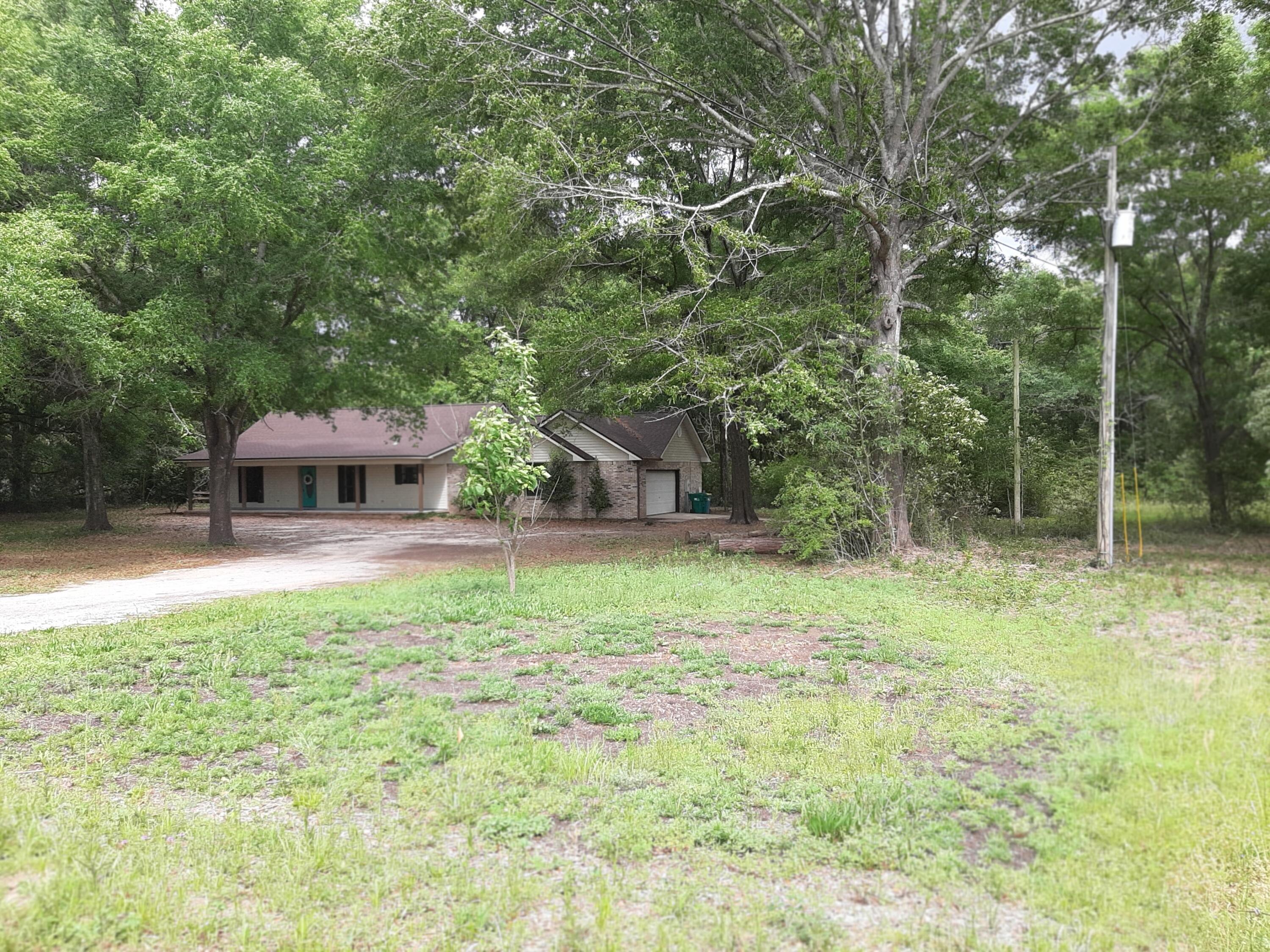 6197 Barnes Road Crestview, FL 32536 - Photo 8 of 35 a house with trees in the background