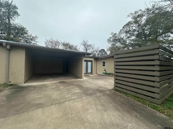 a house that has a tree in front of it