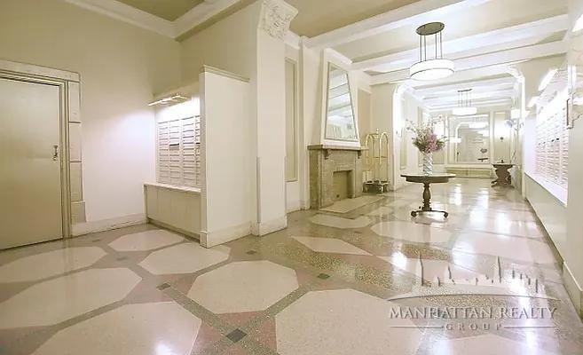 166 2nd Avenue, Unit 15E Manhattan, NY 10003 - Photo 2 of 3 a living room with dining table and chairs