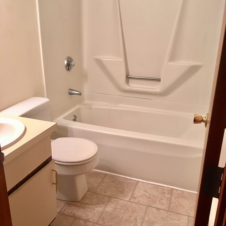 17 Grafton Street, Unit 2 Quincy, MA 02169 - Photo 14 of 25 a bathroom with a toilet a sink and a bathtub
