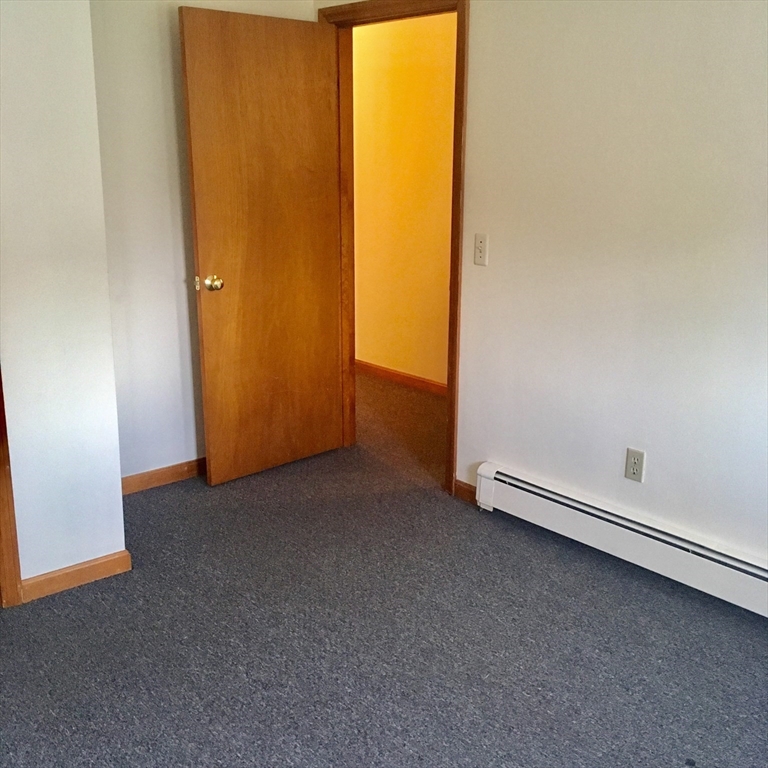 17 Grafton Street, Unit 2 Quincy, MA 02169 - Photo 16 of 25 an empty room with a door