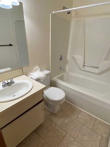 17 Grafton Street, Unit 2 Quincy, MA 02169 - Photo 20 of 25 a bathroom with a sink a toilet and a mirror
