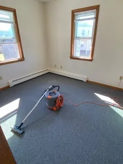 an empty room with windows and closet