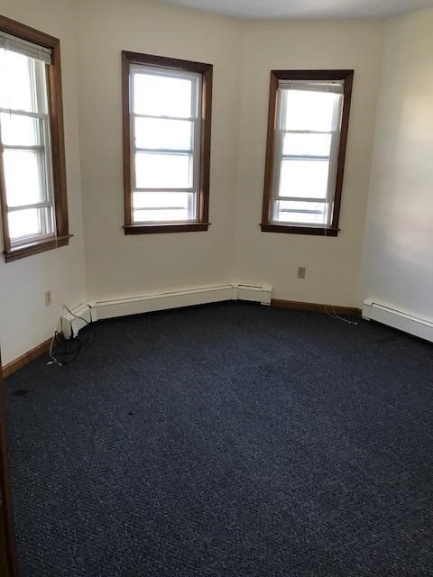 17 Grafton Street, Unit 2 Quincy, MA 02169 - Photo 8 of 25 an empty room with a window