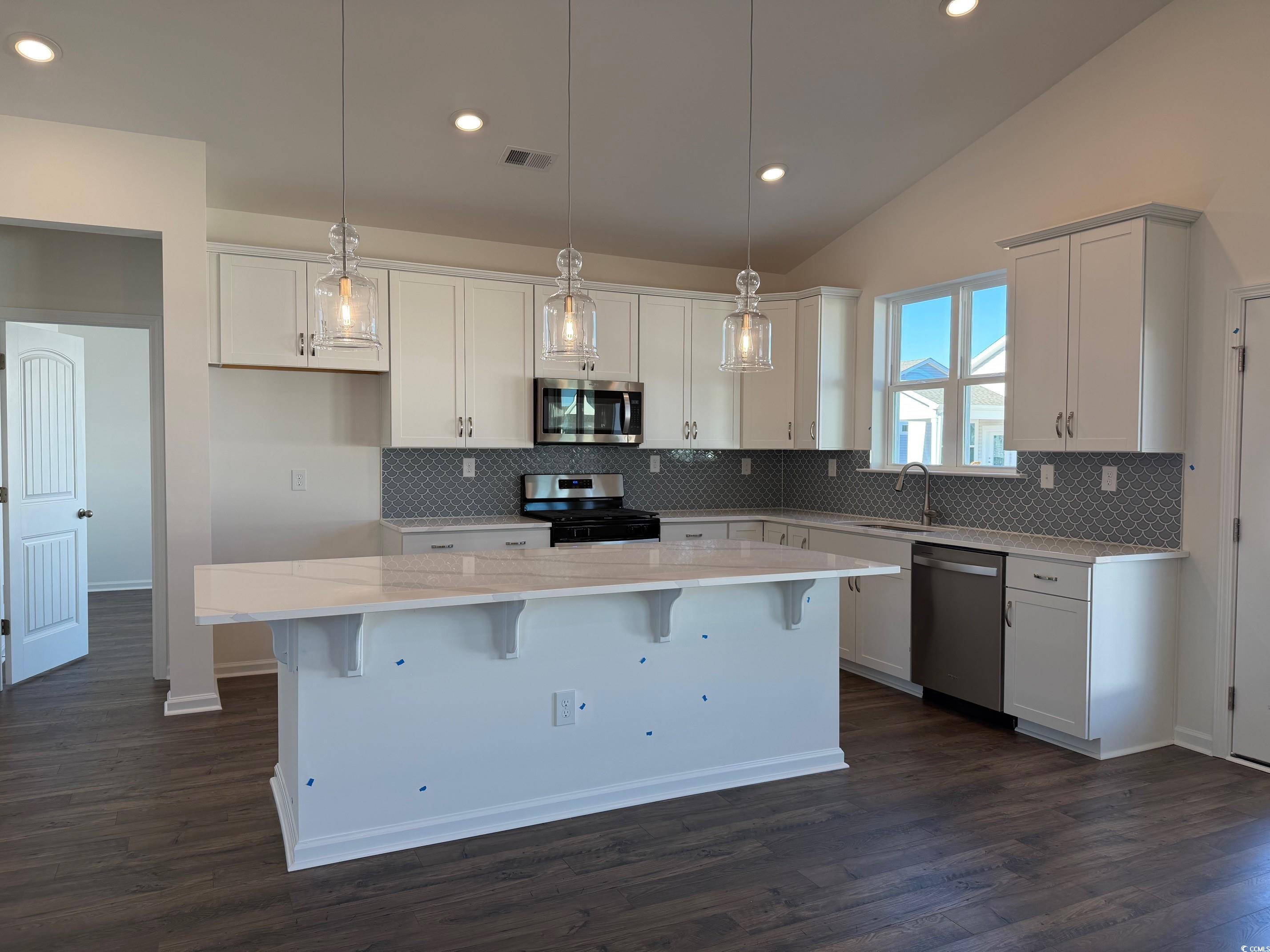 415 Kapalua Loop Little River, SC 29566 - Photo 3 of 19 Living area with lofted ceiling, dark wood finished floors, and recessed lighting