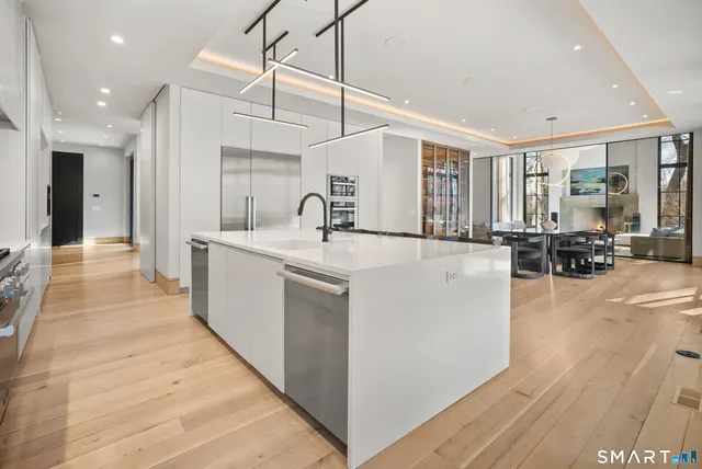 a view of kitchen with sink and refrigerator