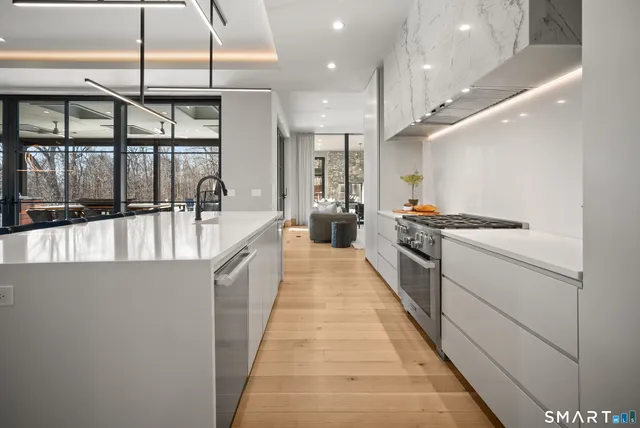 a hallway with a large kitchen view and a counter top space