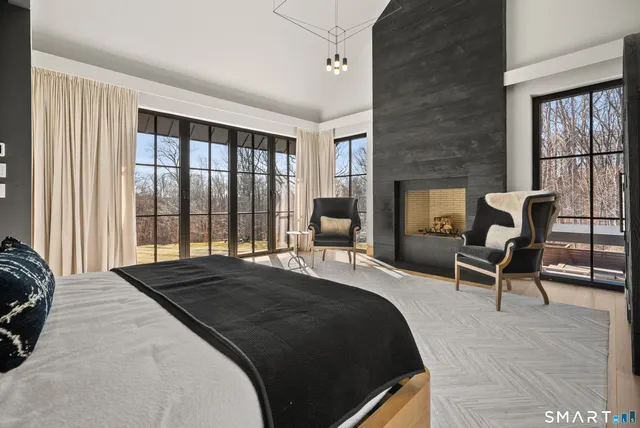 a bedroom with a bed and a large window