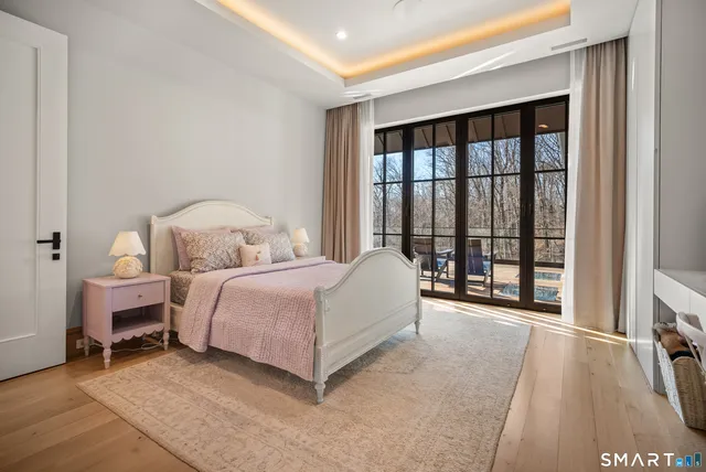 a spacious bedroom with a bed and a large window