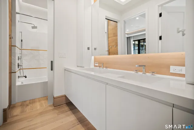 a view of bathroom with bathtub and wooden floor