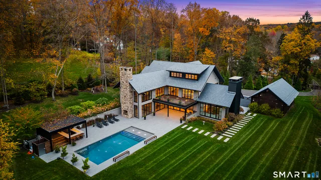 an aerial view of a house with backyard garden and outdoor seating