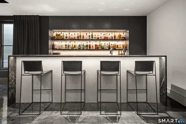 a kitchen with stainless steel appliances kitchen island granite countertop a stove and a refrigerator