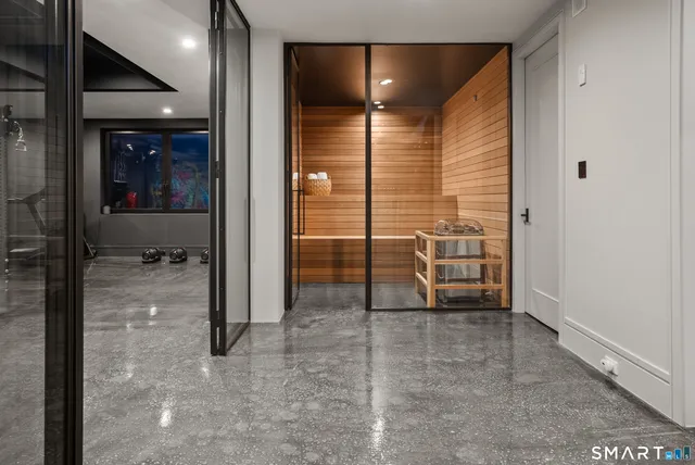 a view of a hallway with a glass door and shower