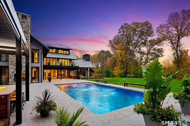 a view of an swimming pool with an outdoor space and seating area