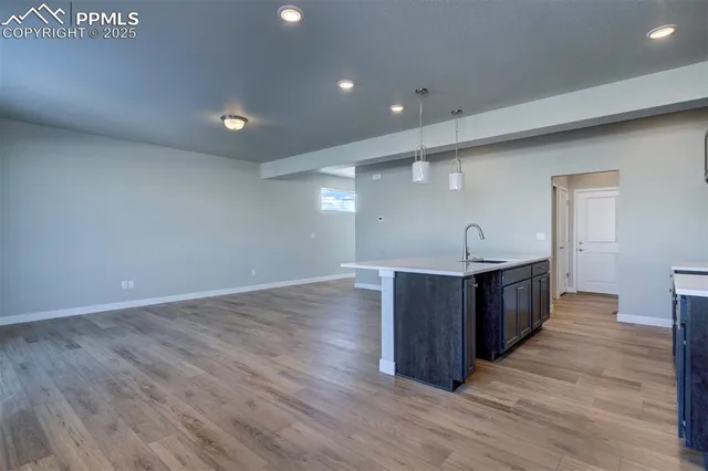 a kitchen with wooden floors and wooden cabinets