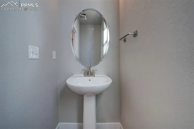 a bathroom with a sink a mirror and vanity