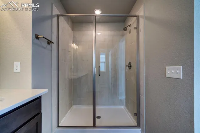 a bathroom with a shower and a sink