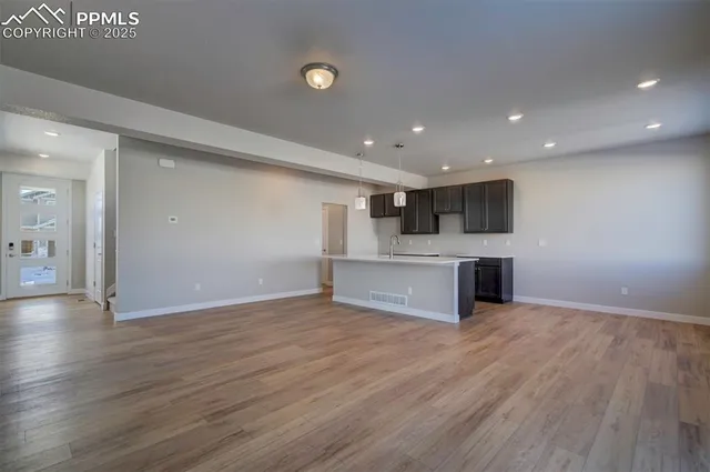 a view of kitchen with cabinets and wooden floor