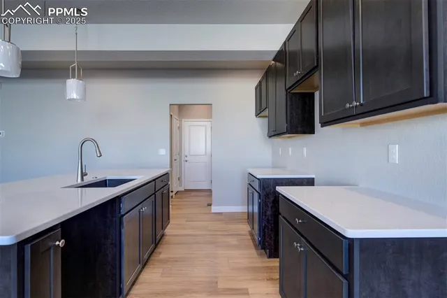 a kitchen with stainless steel appliances a sink a stove and microwave