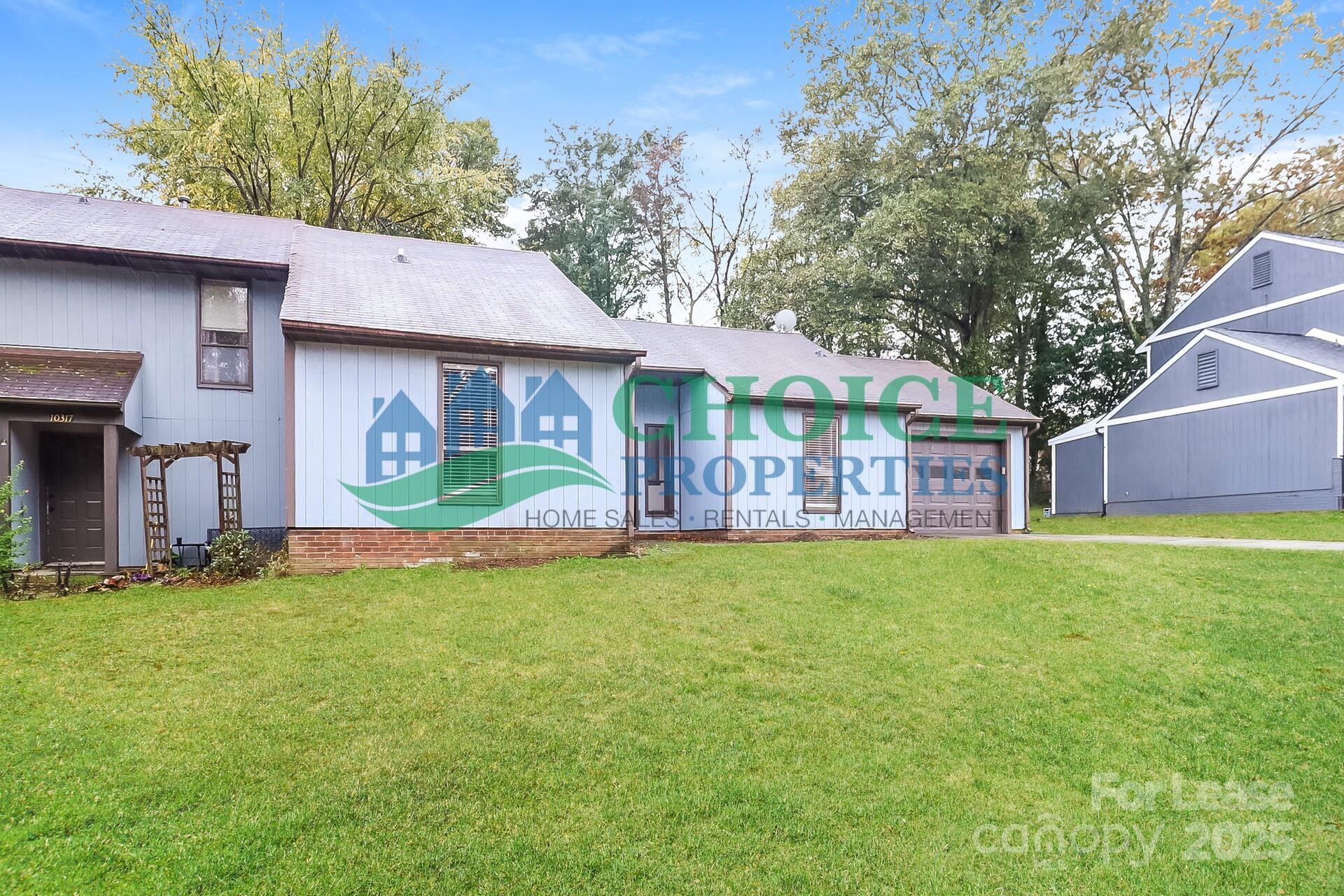 10319 Osprey Drive Pineville, NC 28134 - Photo 3 of 16 a front view of a house with a garden and deck
