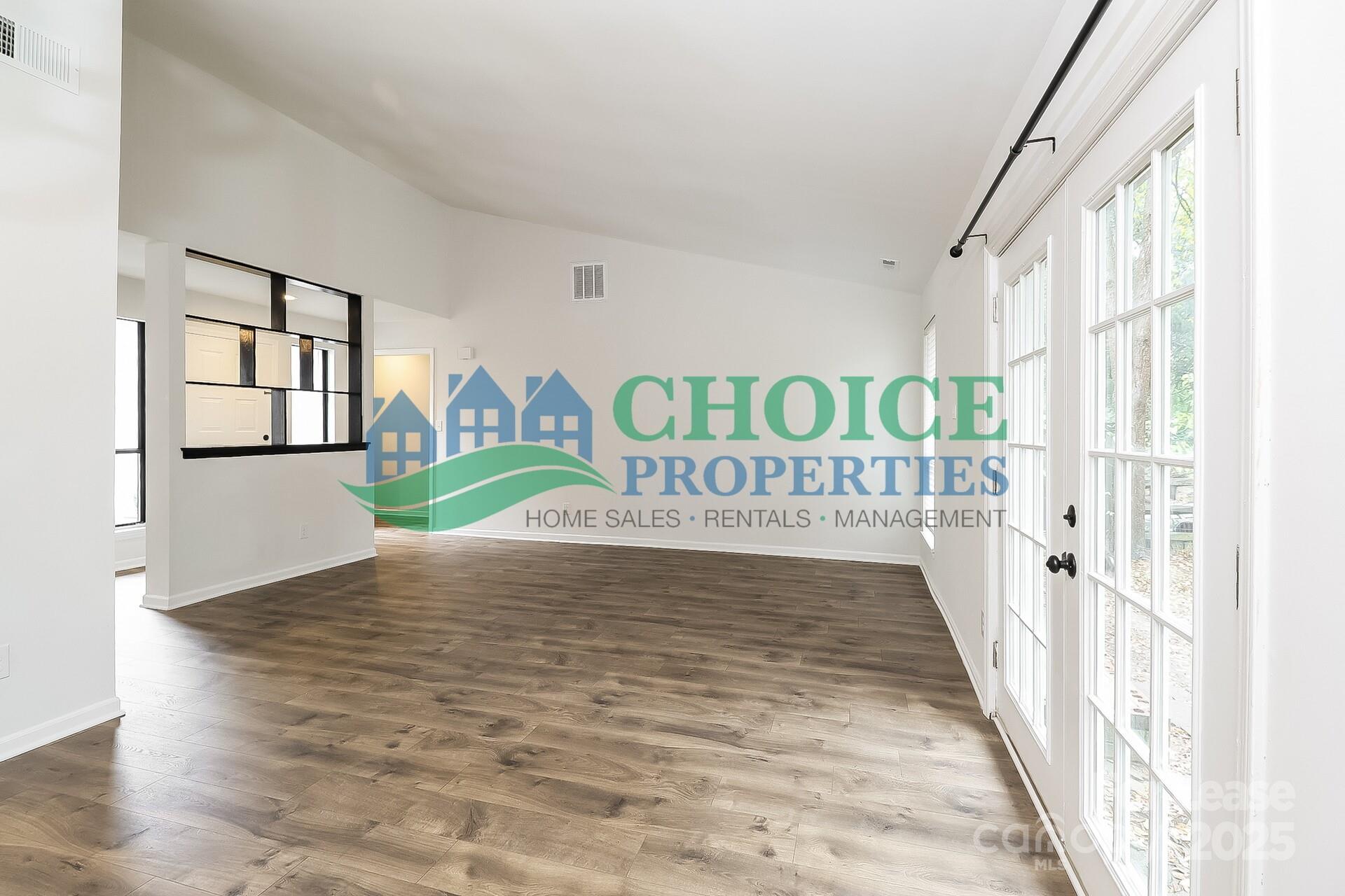 10319 Osprey Drive Pineville, NC 28134 - Photo 4 of 16 a view of a hallway with wooden floor and staircase