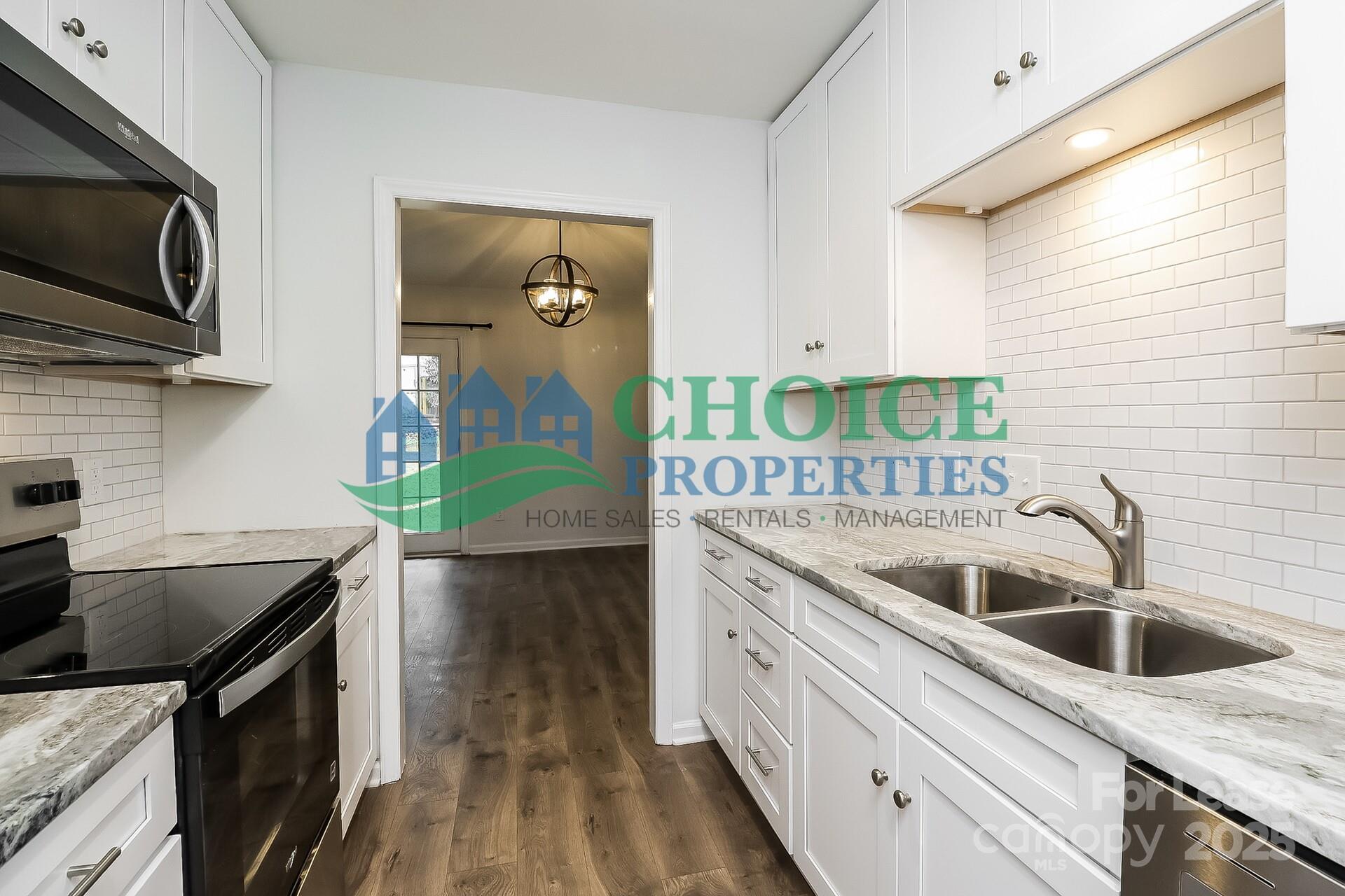 10319 Osprey Drive Pineville, NC 28134 - Photo 9 of 16 a kitchen with a sink and a microwave