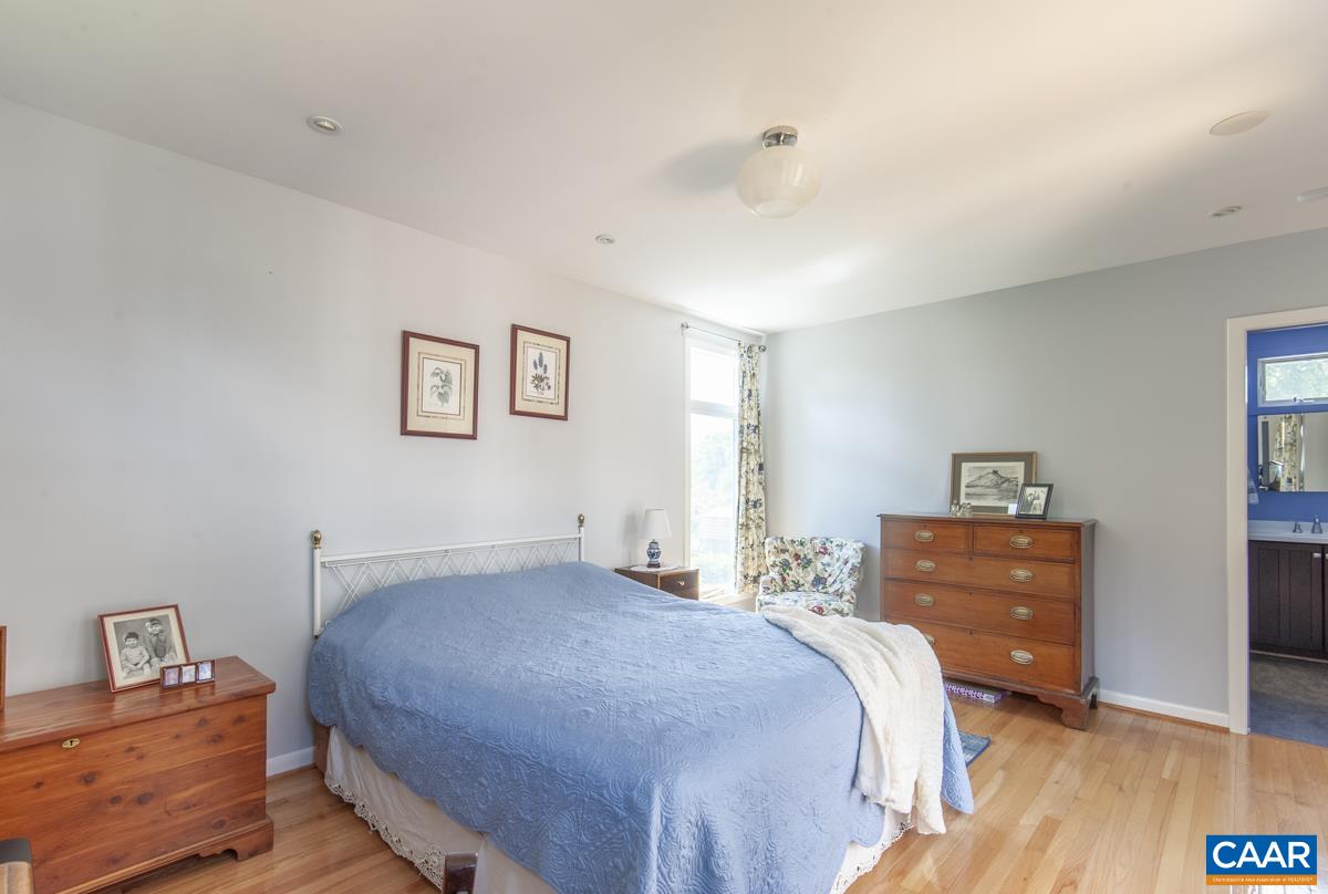 2306 Tarleton Drive Charlottesville, VA 22901 - Photo 19 of 35 a bedroom with a bed and cabinets