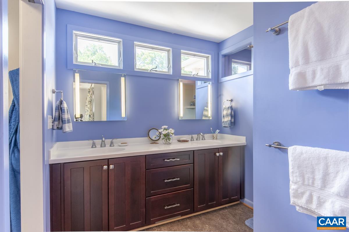 2306 Tarleton Drive Charlottesville, VA 22901 - Photo 20 of 35 a spacious bathroom with a double vanity sink and a mirror